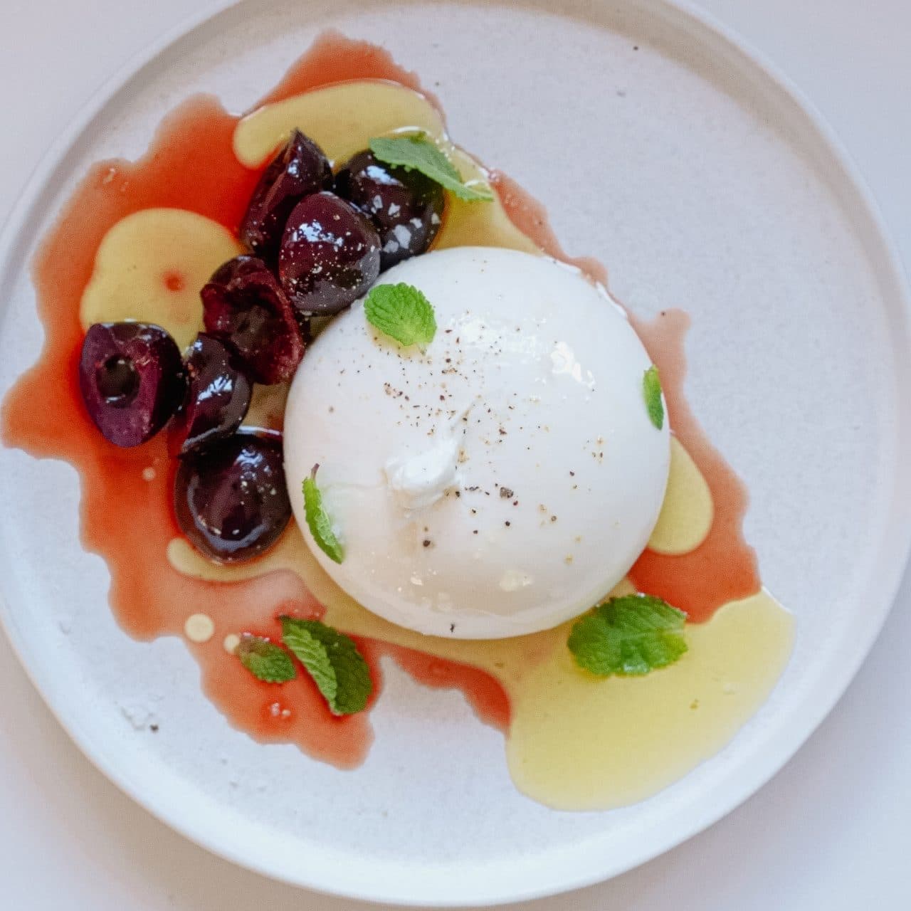 Burrata with pickled cherries & mint by Mateo Zielonka