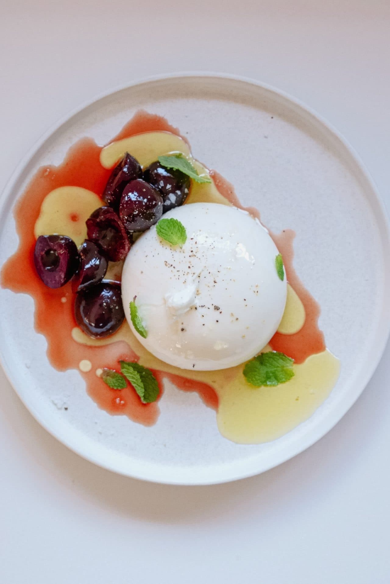 Burrata with pickled cherries & mint by Mateo Zielonka