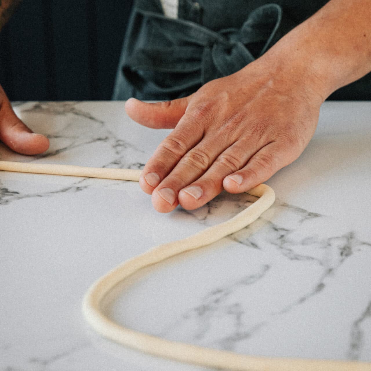 Rolling pasta into long tubes